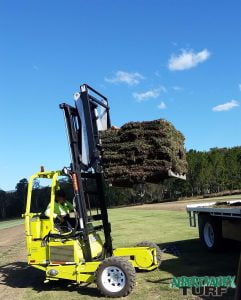 A forklist delivering a stack of turf grass